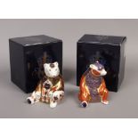 Two Royal Crown Derby Honey Bear paperweights, different patterns, silver stoppers.