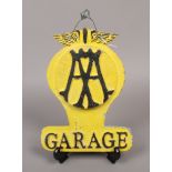 A double sided cast metal AA garage sign, with later paintwork.