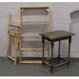 An oak barleytwist occasional table, folding directors chair and a wall mounted shelf.