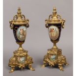 A pair of French Serves style gilt metal mantle urns.