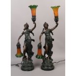 A pair of two branch bronze effect figural table lamps formed as young girls holding coloured