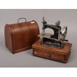 A miniature oak cased dome top baby sewing machine.