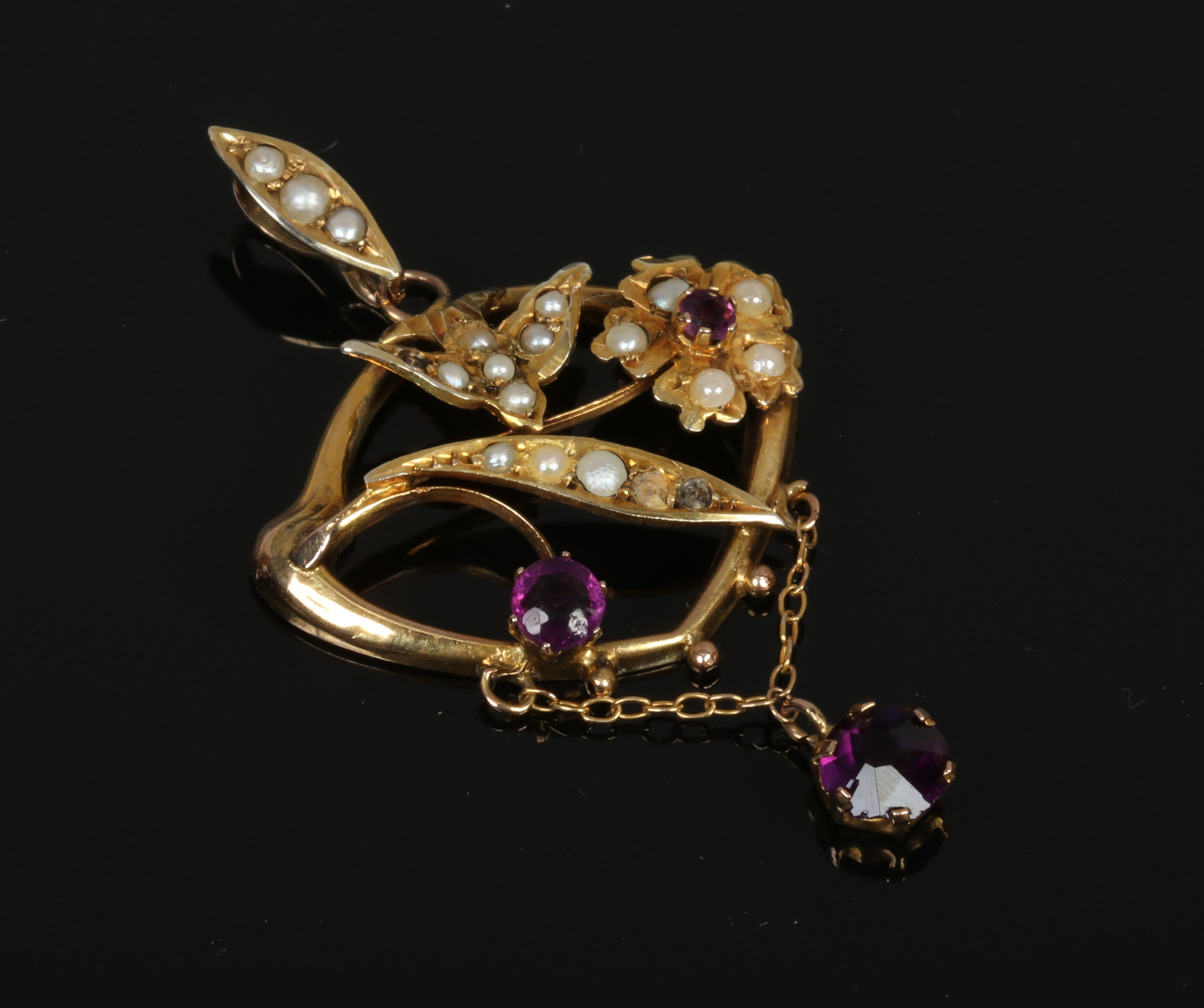 A 9ct gold openwork pendant set with amethyst and seed pearls.Condition report intended as a guide