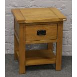 A modern oak side cabinet with single drawer.