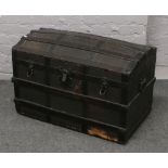 A metal bound dome top travel trunk.