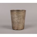 A 19th century Continental silver beaker of tapering form with an engine turned engraved ground