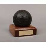 A 16th century cannon ball from The Venetian Gallery recovered 1982 on wooden plinth.