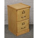 A light oak two drawer filing cabinet H 71cm x W 41cm x D 43cm.