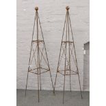 A large pair of iron garden obelisks for climbing plants.