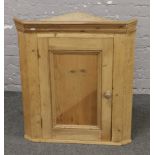 A Victorian carved pine wall mounted corner cupboard.