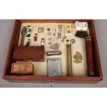 A table top bijouterie cabinet with contents of collectables to include miniature military medals on