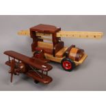 A wooden model of a fire engine, along with a wooden model of a bi plane.