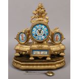 A late 19th century gilded Spelter Serves style mantle clock, raised on gilded and carved wooden