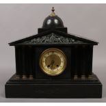 A Victorian black slate 8 day mantle clock half hourly chiming on a gong with pendulum and key.