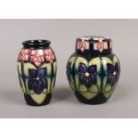 Two pieces of Moorcroft pottery, each decorated in the violet design including a ginger jar shaped