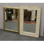 A decorative mirror with foliate strapwork and a gilt framed mirror.