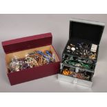 A mirrored jewellery box and a box of costume jewellery to include beads, rings, necklaces etc.