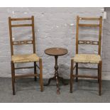 Two Victorian rush seat chairs and a tripod wine table.