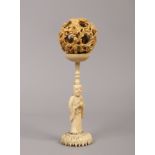 A 19th century Cantonese carved ivory puzzle ball on figural stand, 17cm.Condition report intended