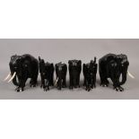 Six ebonised figures of elephants.