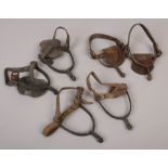 Three pairs of vintage leather and iron spurs.