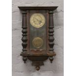 A mahogany cased wall clock with twin train movement chiming on a coiled gong.Condition report
