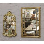 Two gilt framed ornate wall mirrors.