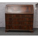 A Victorian mahogany bureau with ebonised mouldings and well fitted interior having faux leather