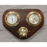 A nautical theme display including brasses cased barometer, thermometer and clock by Viking.