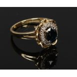 An 18ct gold sapphire and diamond cluster ring on basket setting, gross weight 5.5 grams, size M.