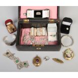 A jewellery box to include silver ring, yellow metal locket, silver bangles etc.