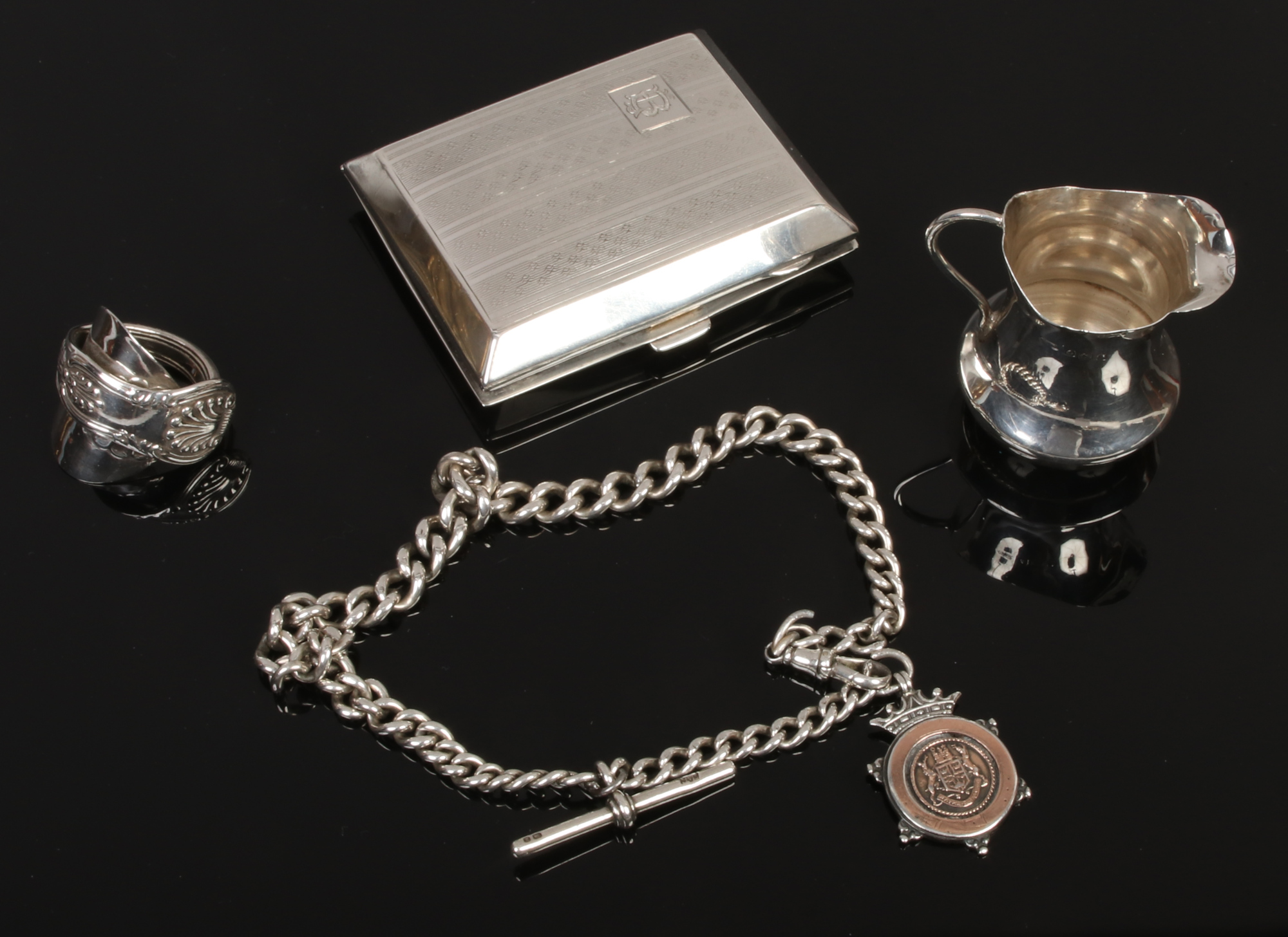 An Edwardian silver miniature cream jug, engraved cigarette case, Kings pattern spoon ring and a