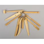 A collection of Victorian ivory teething bars formed as miniature tools.