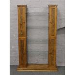 A carved hardwood Chinese style twin pedestal display cabinet with four central glass shelves,