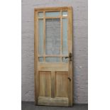 A pine exterior door with lead glazed panels and original lock and keys.