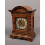 An 8 day walnut bracket clock with dome top.Condition report intended as a guide only.Missing