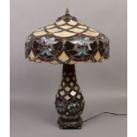 A Tiffany style table lamp with coloured leaded glazed shape and base, 70cm x 45cm.Condition