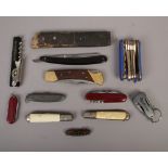 A box of assorted pocket knives including multi tool examples etc.