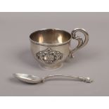 A Russian silver vodka cup with beaded rim and scrolling handle with applied cartouche inscribed B.R