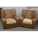 A pair of 1950s wing back leatherette arm chairs.