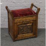 A Victorian carved mahogany upholstered top piano stool.