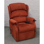 A red upholstered electric reclining arm chair.