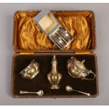 A cased Joseph Gloster silver condiment set,, along with two silver napkin rings.