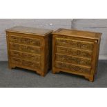 A pair of carved hardwood Chinese style chests of drawers, decorated with figures in landscapes.