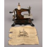 A vintage German child's / miniature hand crank sewing machine.