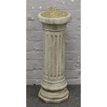 A brass sun dial on reeded cast column base.