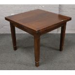 A mahogany drawer leaf table raised on square cut tapering spade foot legs.