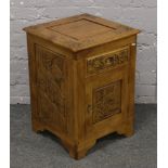 A carved hardwood Chinese style side cabinet decorated with figures in landscapes.