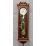 A James Stewart double weight Vienna wall clock chiming half hourly with pendulum and key.