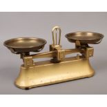 A small set of brass kitchen scales.